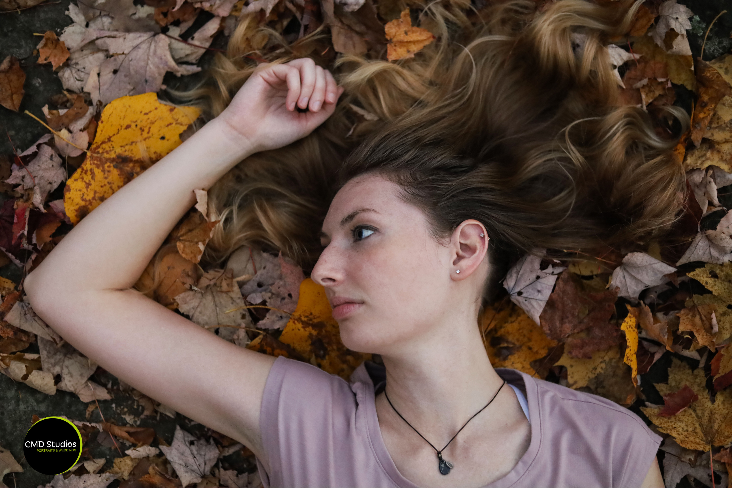 girl laying in leaves