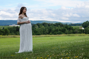 pregnant woman in field standing